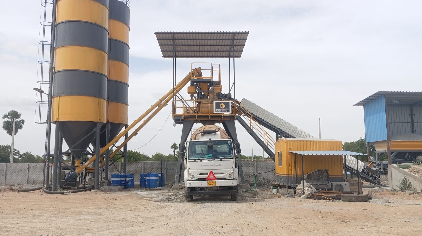 CONMAT concrete batching plant with transit mixer under the loading gantry
