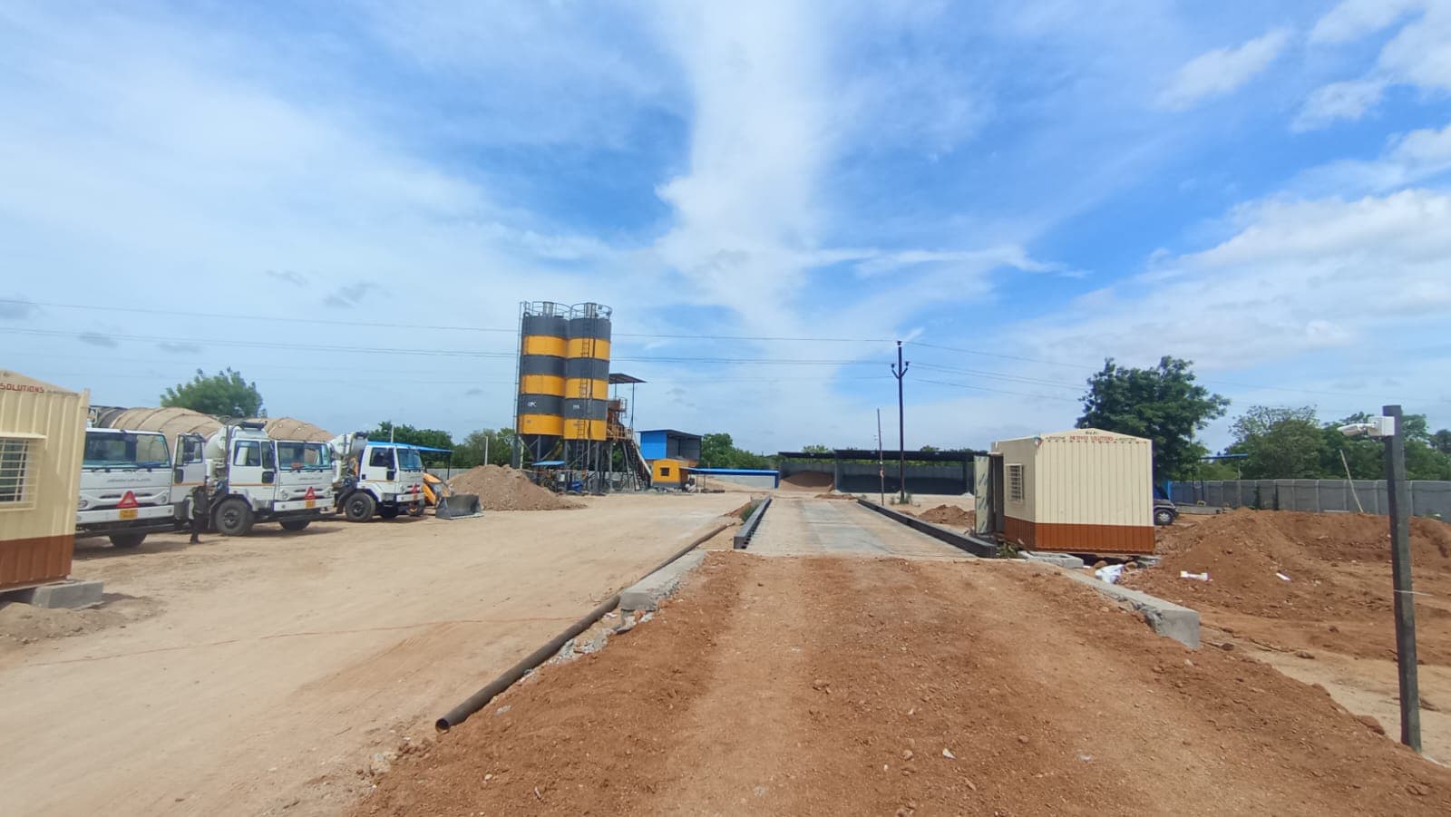 Plant weighbridge yard with silos and transit mixers ready for dispatch