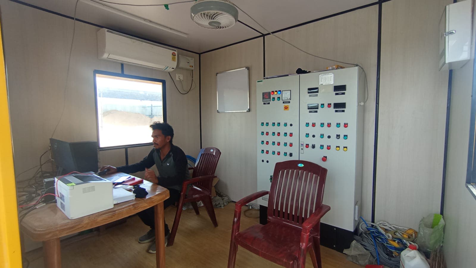 Plant control room with operator and industrial batching control panel